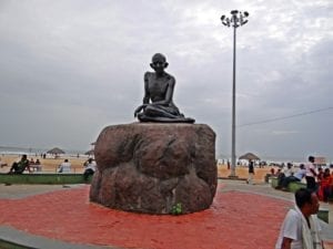 statue of Gandhi on cross-legged on a boulder